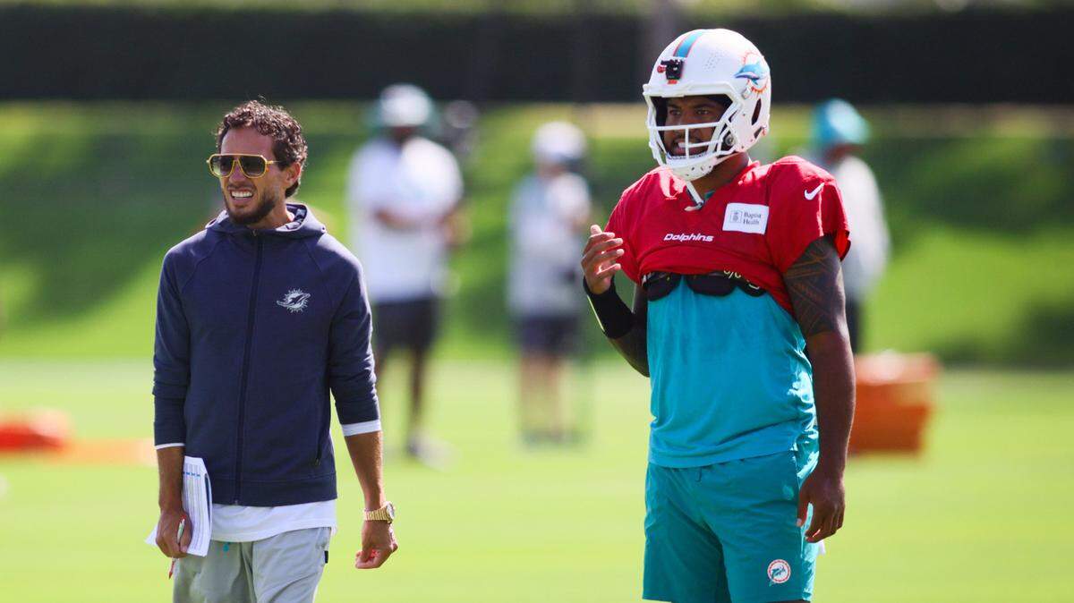 Miami Dolphins head coach Mike McDaniel and quarterback Tua Tagovailoa (1) look on during training camp at Baptist Health Training Complex in Miami Gardens, Florida, on Tuesday, August 20, 2024.