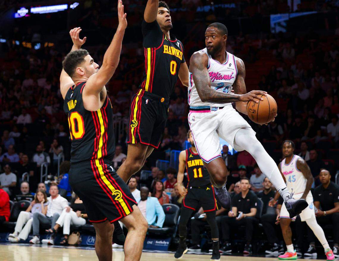 Miami Heat forward Haywood Highsmith (24) jumps around Atlanta Hawks forward Dominick Barlow (0) during the first half of a game on Thursday, March 27, 2025, at the Kaseya Center in downtown Miami, Fla. 