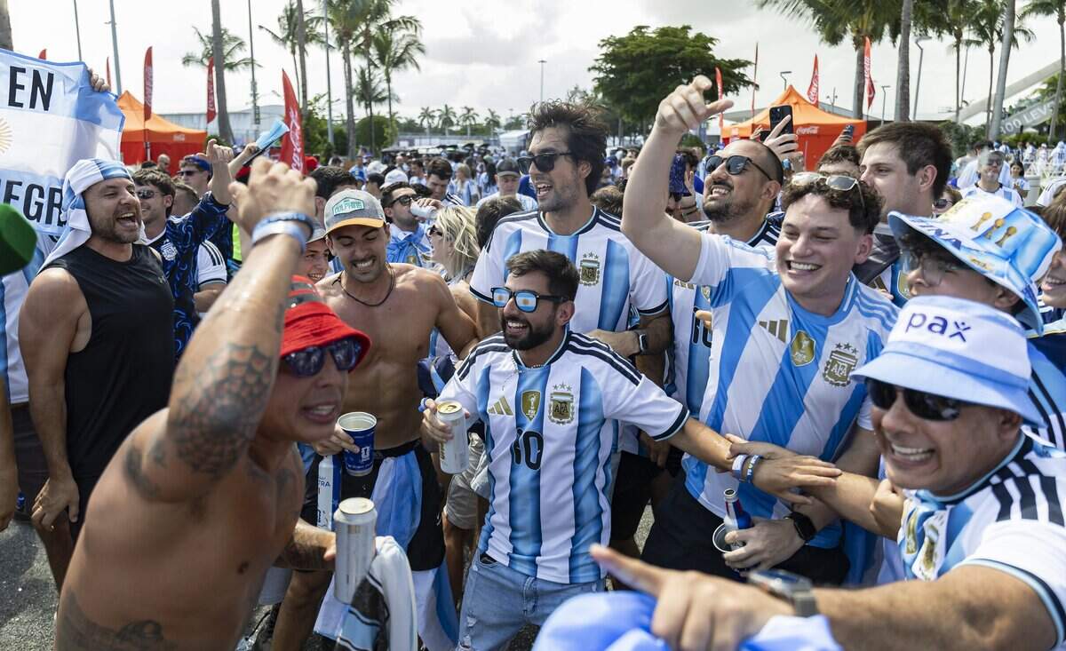 Argentina fan Leandro Yusep, center, dances and sings as he arrives to the Hard Rock Stadium (Miami Stadium) for the FIFA World Cup 2026 Round of 32 soccer match against Cape Verde on Friday, July 3, 2026, in Miami Gardens, Fla.
