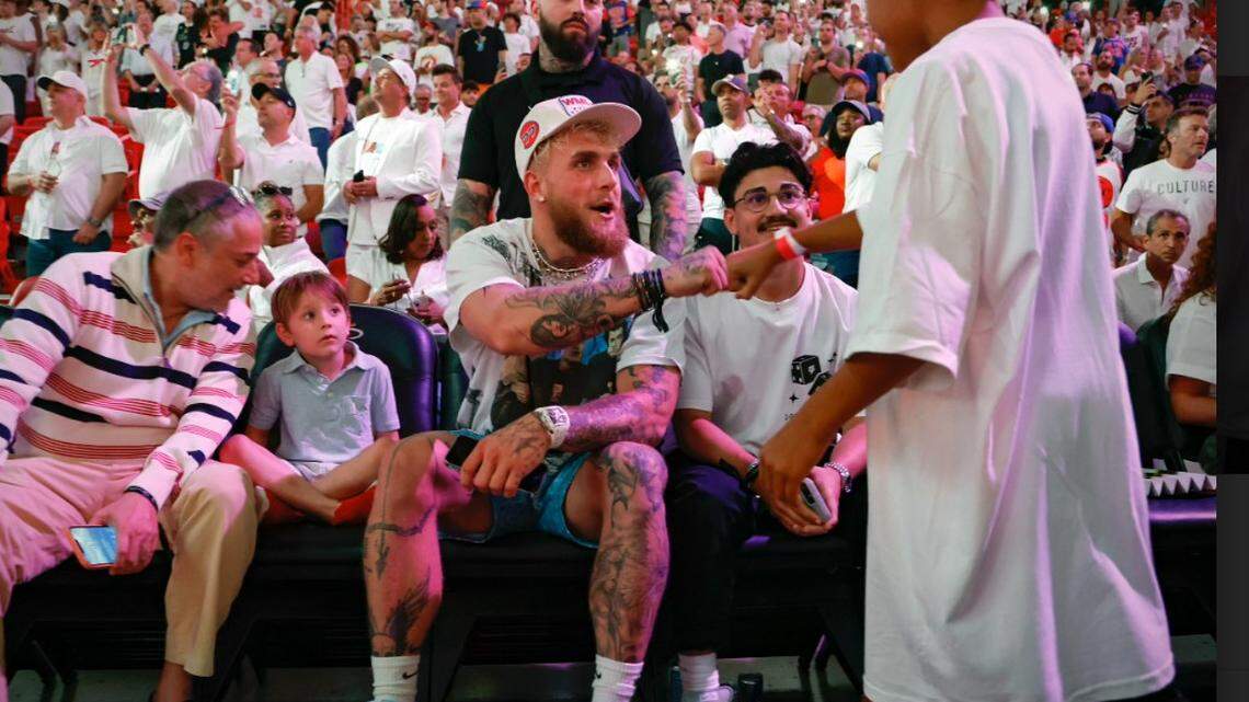 You Tube star Jake Paul sits in the front row of the Miami Heat vs. New York Knicks Eastern Conference Semifinal  Saturday afternoon at the Kaseya Center in downtown Miami 