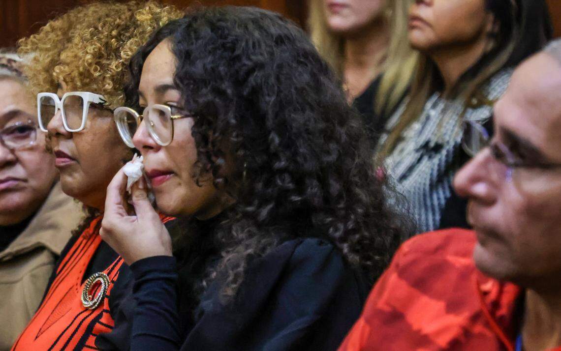 Angelica Lugo, center, and Odalis Benavides, left, the daughter and wife of Osmel Lugo-Gutierrez, sit side by side as Angelica wipes her tears as Lugo-Gutierrez is sentenced on Wednesday, January 14, 2026. Lugo-Gutierrez was convicted of manslaughter for killing Franklyn Pineyro inside a Coral Gables Publix.