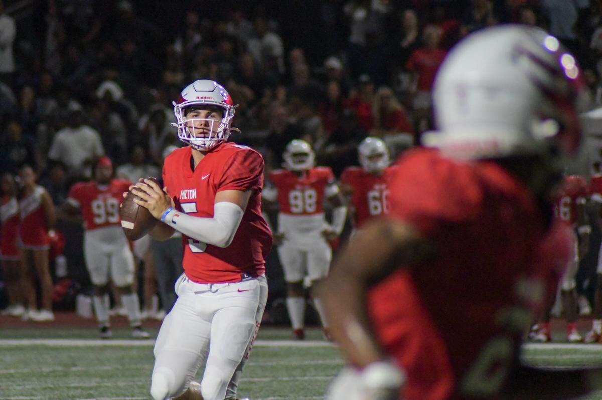 Milton quarterback Luke Nickel drops back to pass against American Heritage on Friday, Aug. 23, 2024, in a Broward County High School National Football Showcase game at St. Thomas Aquinas in Fort Lauderdale, Florida.