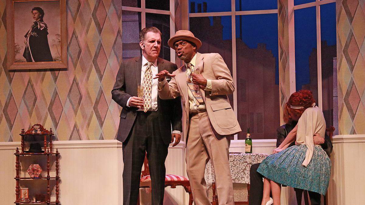 Paul Louis and Reggie Whitehead trade information as Clay Cartland and Leah Sessa cuddle in the Actors’ Playhouse production of “One Man, Two Guvnors.”