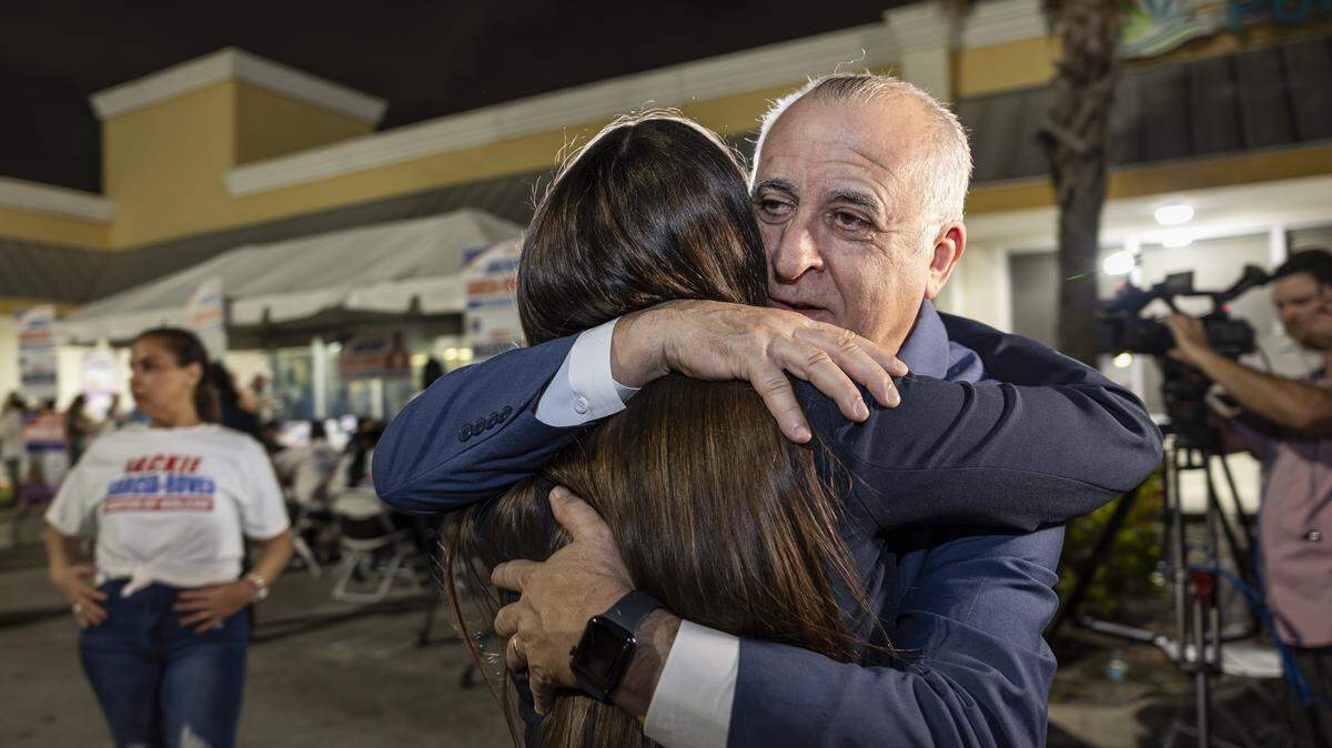 Interim Mayor Jackie Garcia-Roves is hugged by former Hialeah Mayor Esteban Bovo after losing the Hialeah mayoral race to Bryan Calvo on Tuesday, Nov. 4, 2025, in Hialeah, Fla.