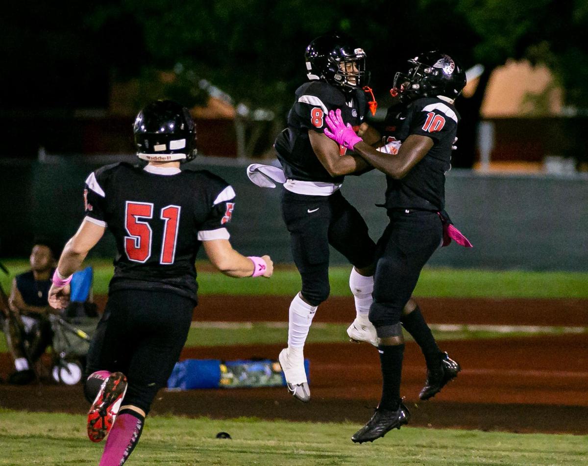 Southridge Spartan running back Jaden Miller (10) and wide receiver Cameron Owens (8) celebrate after scoring a touchdown against the Homestead Broncos during the first quarter of a high school football game at Southridge Park on Friday, Oct. 14, 2022, in Miami, Fla.