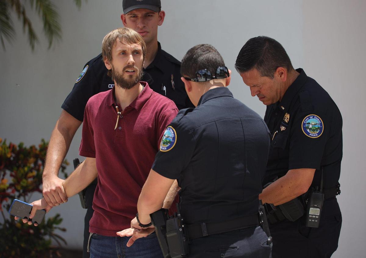 Morgan Gianola, 30, was removed from an event where Gov. Ron DeSantis spoke and was briefly detained by police. On Sunday, August 21, 2022, protesters gathered outside the Metro-Dade Firefighters Local 1403 in Doral as DeSantis spoke in favor of school board candidates he endorsed.
