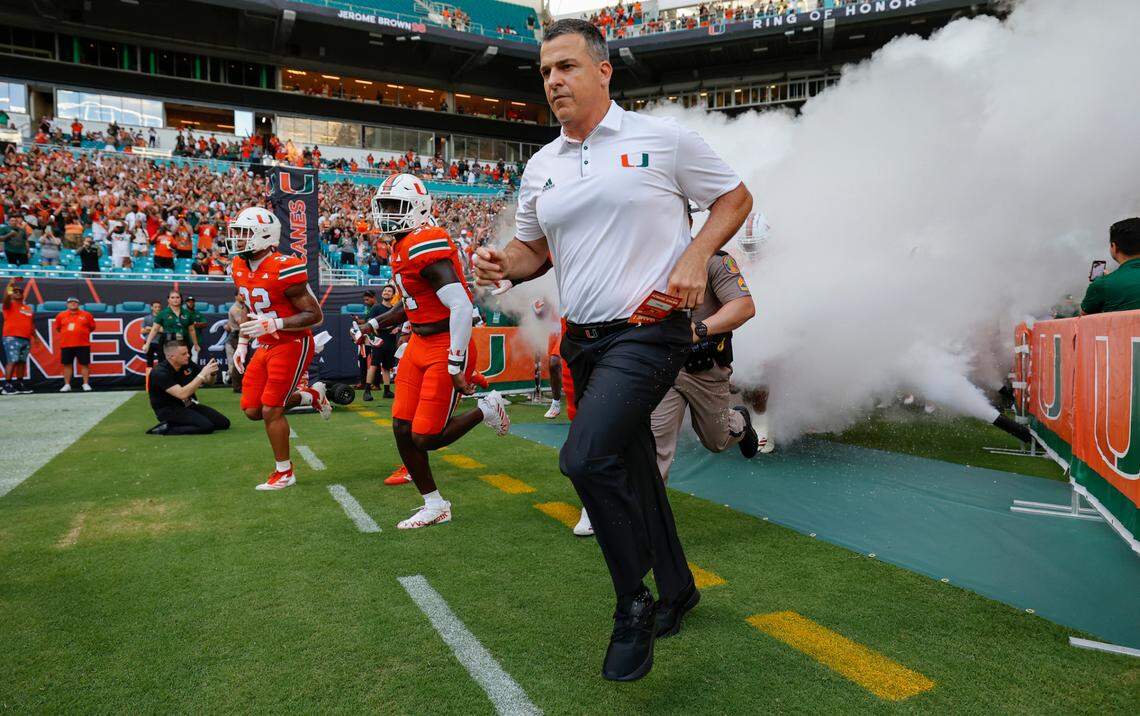 Miami Hurricanes head coach Mario Cristobal runs onto the field before the start of the game against the Florida A&M Rattlers at Hard Rock Stadium in Miami Gardens, Florida, on Saturday, September 7, 2024. 