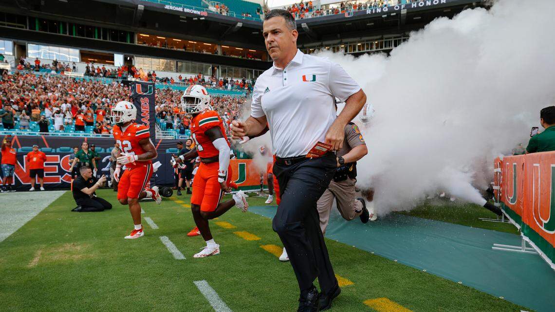 Miami Hurricanes head coach Mario Cristobal runs onto the field before the start of the game against the Florida A&M Rattlers at Hard Rock Stadium in Miami Gardens, Florida, on Saturday, September 7, 2024.