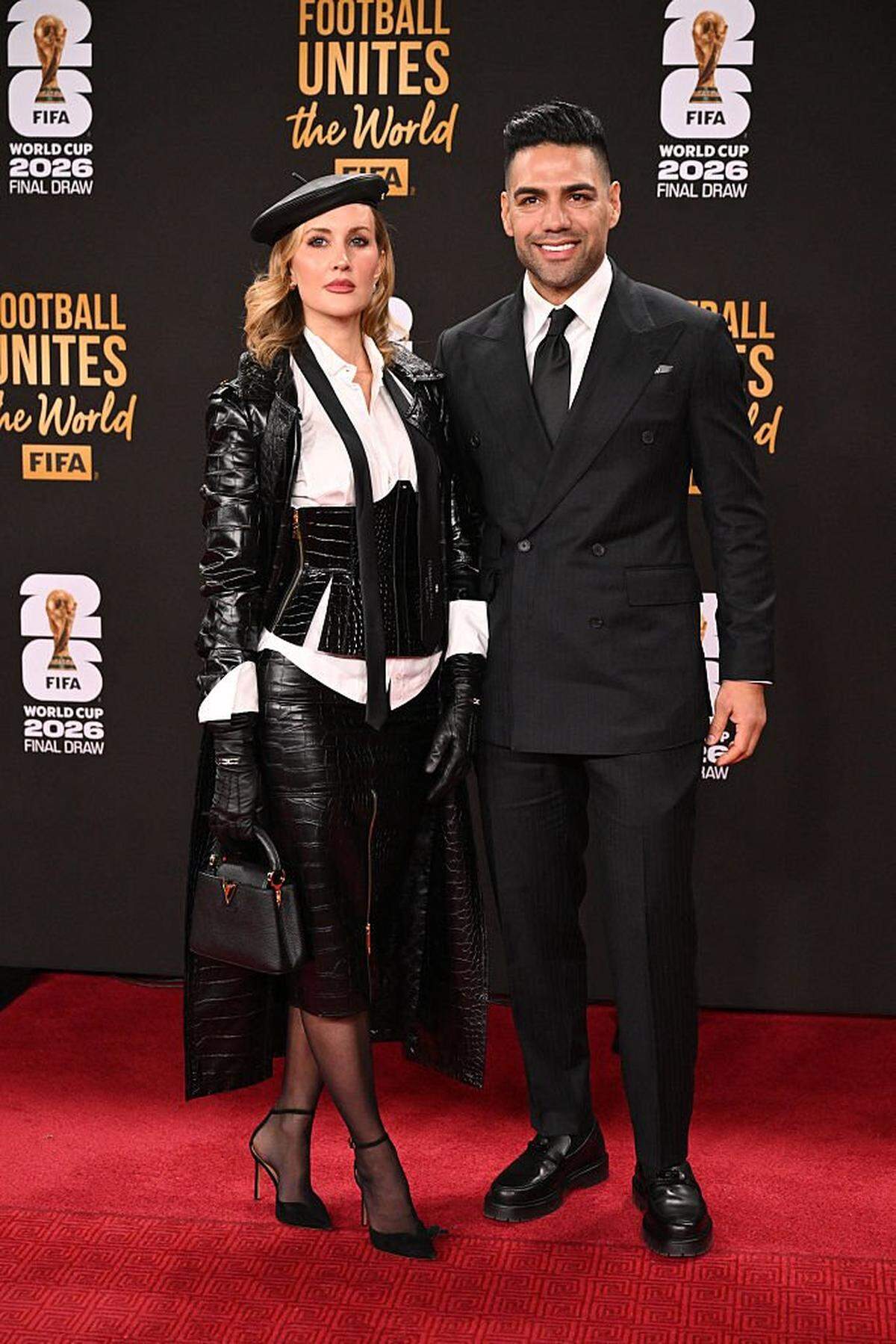 Former Colombian football player Radamel Falcao (R) and wife Lorelei Taron pose on the red carpet upon arrival to attend the draw for the 2026 FIFA Football World Cup taking place in the US, Canada and Mexico, at the Kennedy Center, in Washington, DC, on December 5, 2025. (Photo by Roberto SCHMIDT / AFP via Getty Images)
