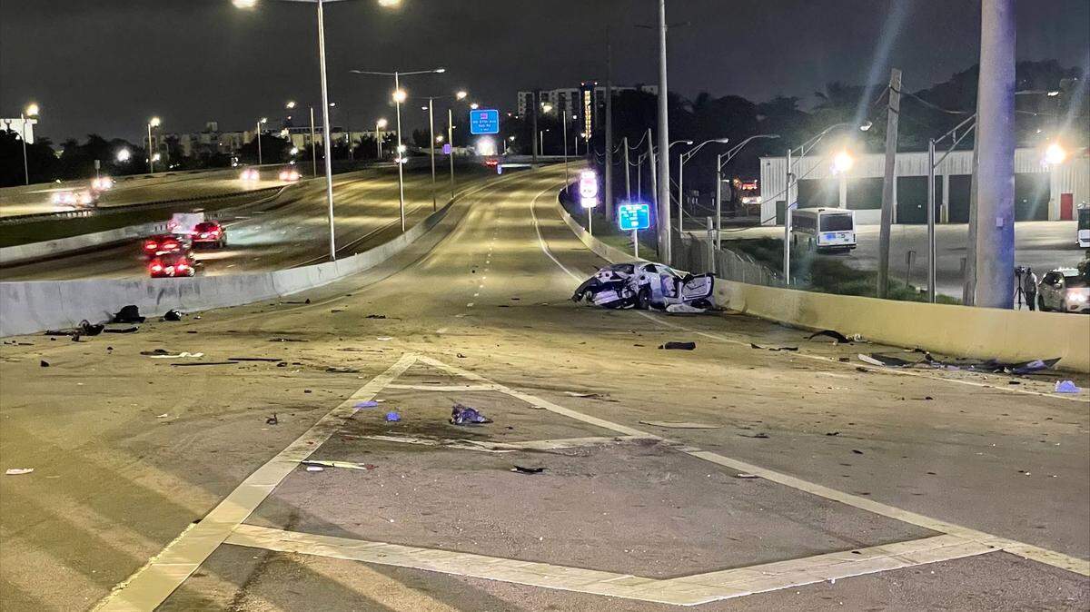 The remains of a 3:50 a.m. crash that shut down LeJeune Road’s entrances to the Dolphin Expressway into Wednesday morning’s rush hour. Both driver and passenger were killed.