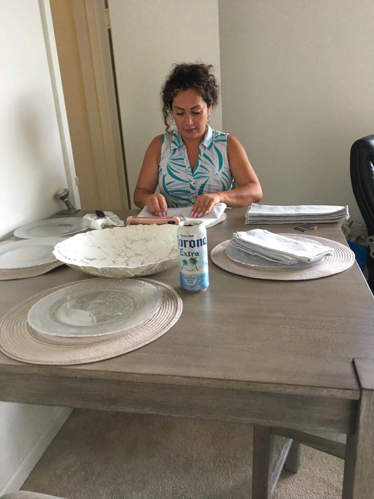 Natalia Ochoa helps former Guatemala top prosecutor Thelma Aldana unpack donated goods.