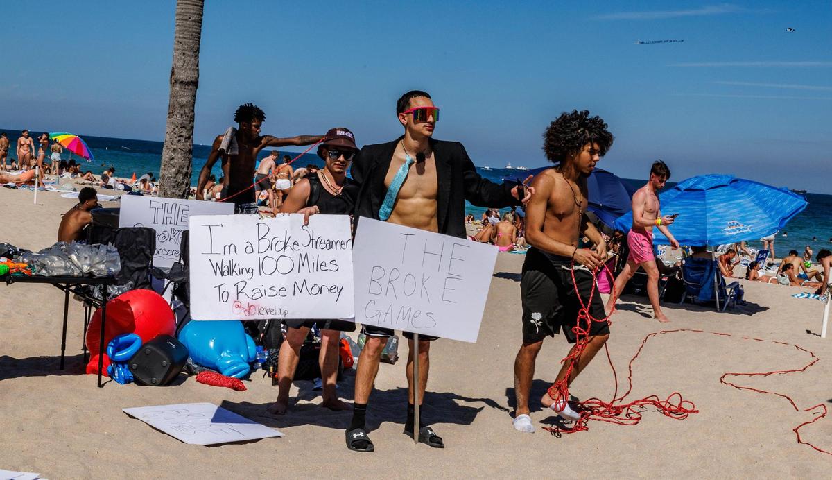 Content creator Josiah Garcia (center) sets up for his own creation “The Broke Games” at Fort Lauderdale Beach during spring break, on Thursday March 20, 2025.