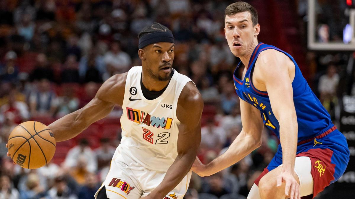 Miami Heat forward Jimmy Butler (22) dribbles while Denver Nuggets forward Vlatko Cancar (31) defends during the first quarter of an NBA game at Miami-Dade Arena on Monday, Feb. 13, 2023, in Miami.