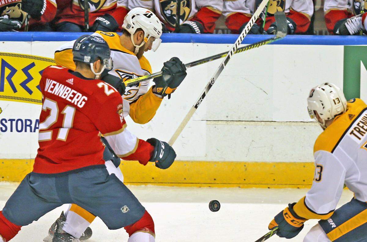 Florida Panthers Alex Wennberg (21) and Nashville Predators Jarred Tinordi (24) in the first period at the BB&T Center in Sunrise, Florida, Thursday, February 4, 2021.