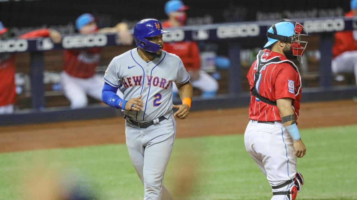 New York Mets first baseman Dominic Smith (2) scores the go ahead run against Miami Marlins in the 12th inning during baseball game at loanDepot park in Miami on Friday, May 21, 2021.