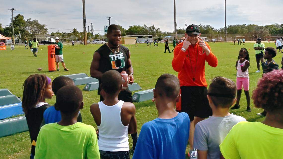 Miami Hurricanes safety Jaquan Johnson and outside linebackers coach Jonathan Patke speak to kids at a Mark Richt satellite youth football camp at Richmond Park in Miami on Tuesday, June 12, 2018.