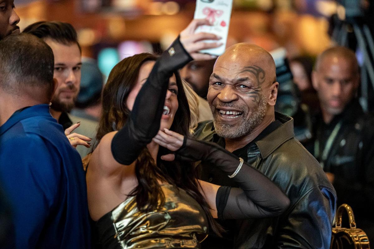 Mike Tyson poses for a selfie with model Brooks Nader after placing they placed sports bets during the launch event at the Seminole Hard Rock Hotel & Casino Hollywood, Thursday, December 7, 2023.