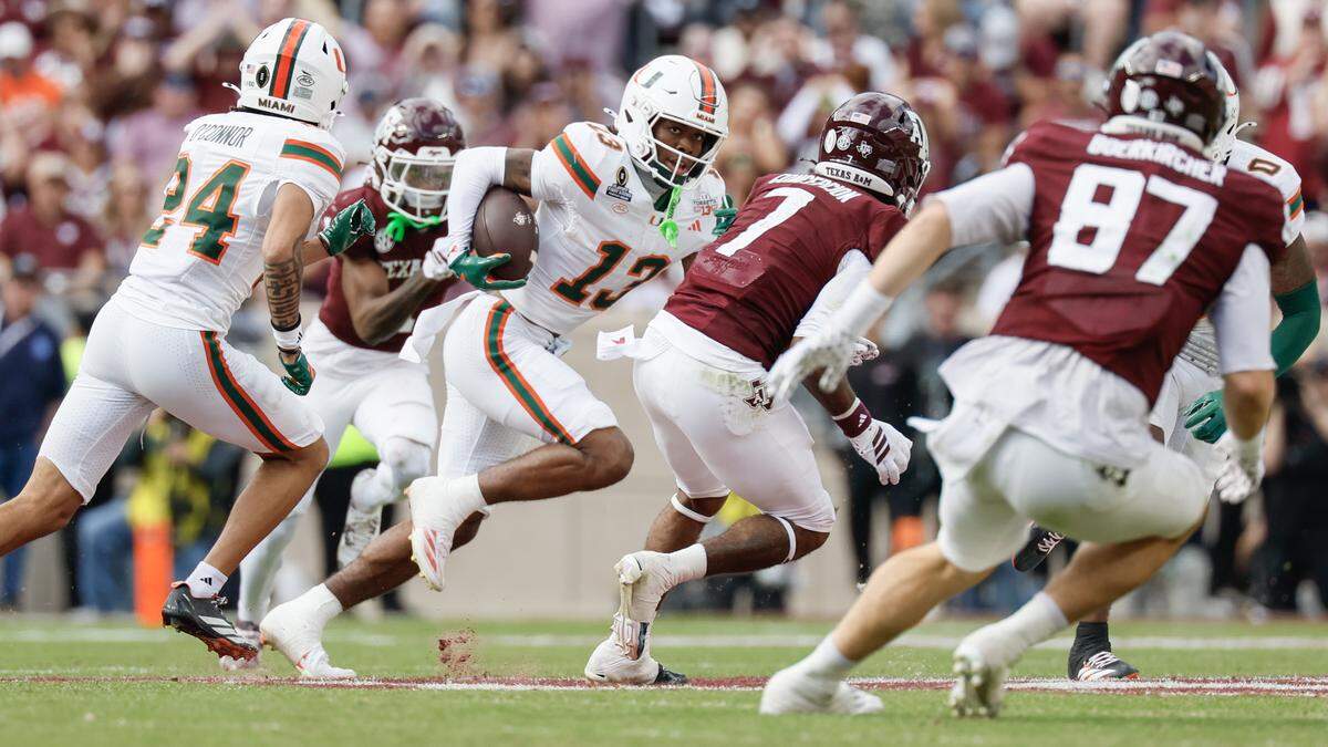 Miami Hurricanes defensive back Bryce Fitzgerald (13) intercepts the ball in the second half against the Texas A&M Aggies of the first round of the 2025 College Football Playoff at Kyle Field at College Station, Texas, on Saturday, December 20, 2025.