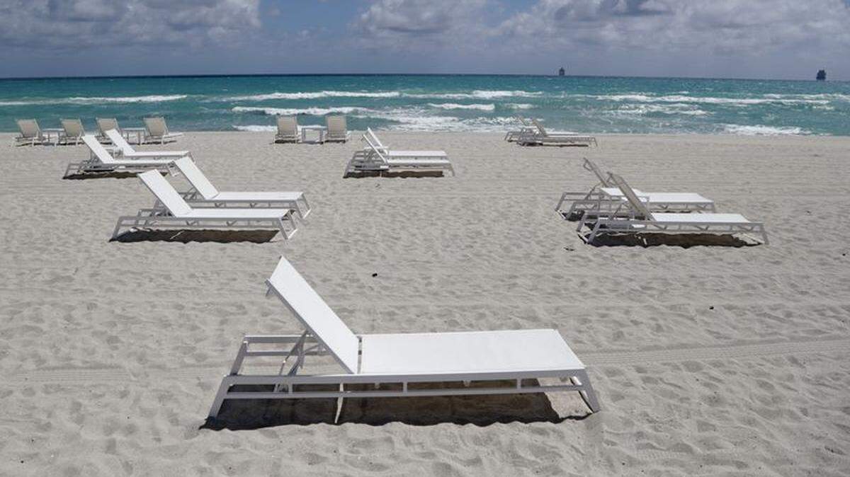 Empty chairs sit on the sand in Miami Beach in March.