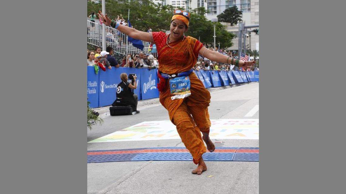 Nilima Pai, a barefoot runner who came to Weston from India in 2015, crosses the finish line of the Miami Marathon in 2018.