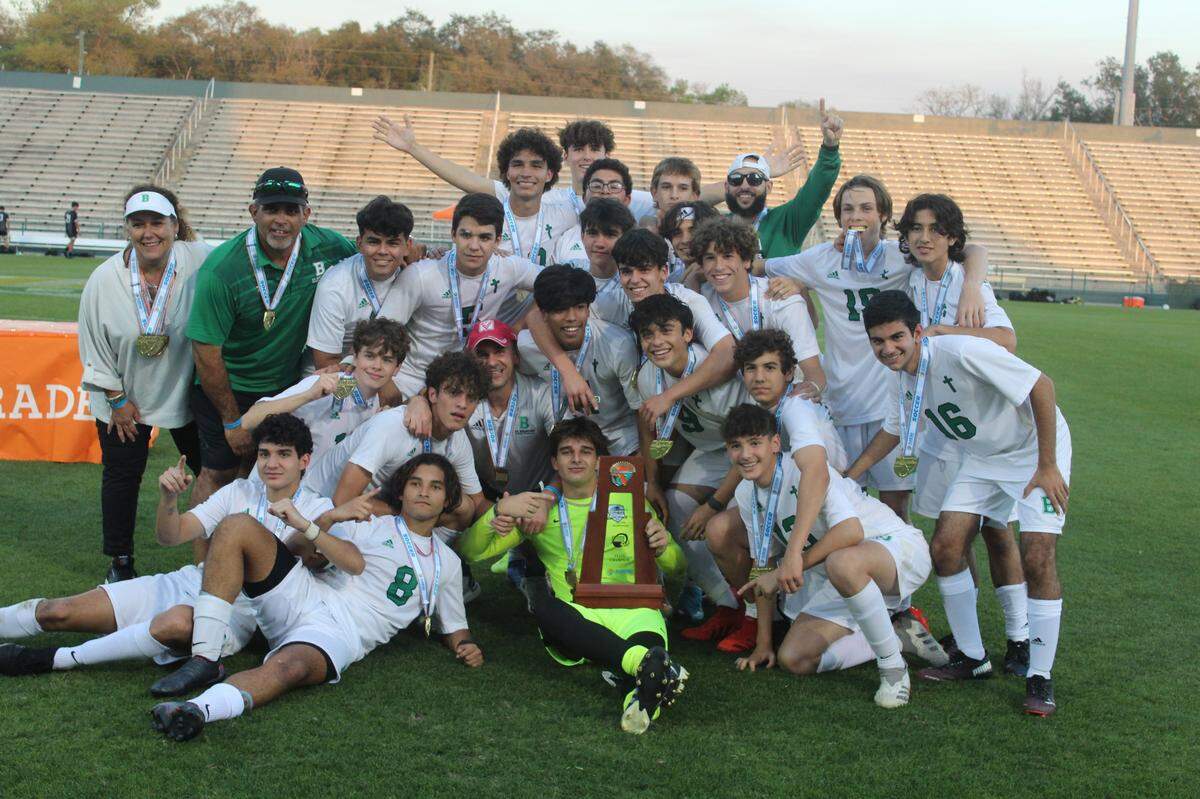 St. Brendan players and coaches celebrate the school’s first-ever state championship in boys soccer and the first in a boys sport since its baseball team won in 1983.