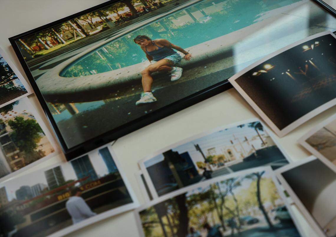 Photographs by local photographers are displayed on a table prior to being framed and installed. Four high school students installed photos inside the First Church Miami coffee shop for the exhibition Sparrow, featuring the photography of local photographers navigating homelessness under the artistic direction of Miami-based artist Christopher Mitchell on Sunday, November 30, 2025.