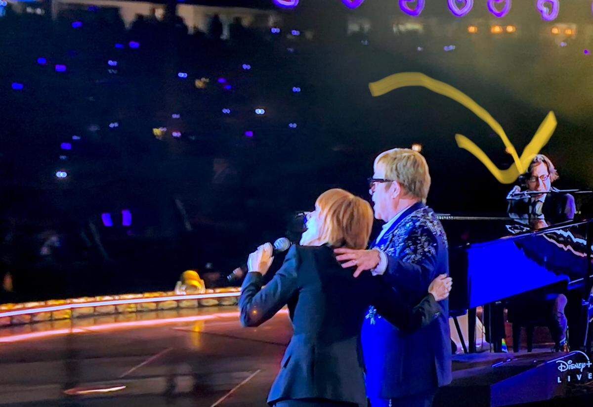 Screen grab from the Disney+ livestream presentation of Elton John’s Farewell Yellow Brick Road U.S. closing date from Dodger Stadium on Nov. 20, 2022. The arrow points to musician Adam Chester of Miami Beach, who now lives in Los Angeles and who is Elton’s rehearsal pianist. He is seen here playing piano at Elton’s keyboard as Elton and Kiki Dee sing their 1976 No. 1 hit, “Don’t Go Breaking My Heart.”