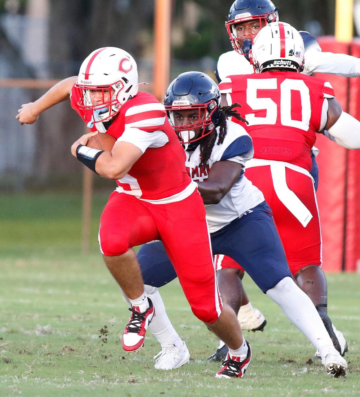 Plantation Colonels quarterback Jayden Chico tries to break free from Miramar Patriots defenders during football game on Friday, August 30, 2024 at PAL Field in Plantation. Andrew Uloza / for Miami Herald