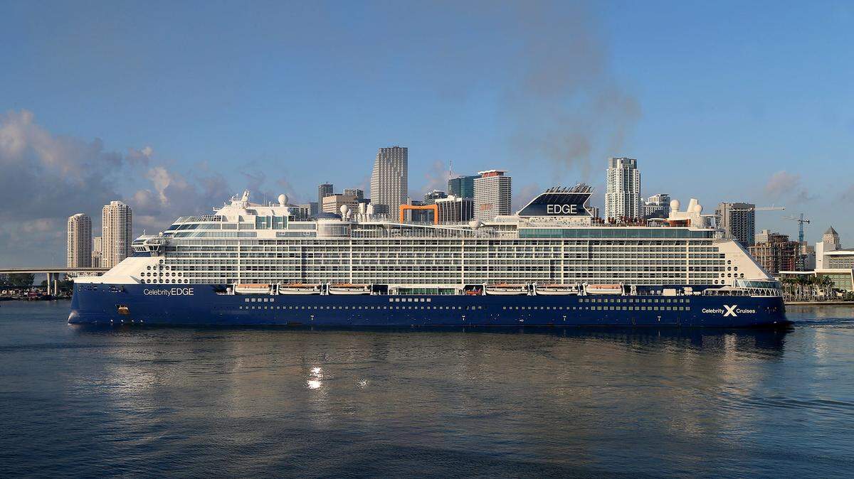 Celebrity Edge cruise ship blocks the view of the Miami skyline while arriving at PortMiami in the early morning on August 6, 2020.