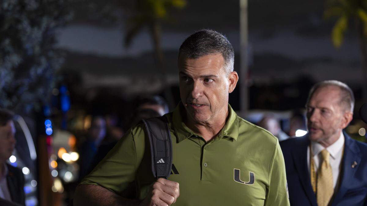 Miami Hurricanes head coach Mario Cristobal arrives with his team to the Fontainebleau Miami Beach ahead of their College Football Playoff National Championship Game against the Indiana Hoosiers on Friday, Jan. 16, 2026, in Miami Beach, Fla.