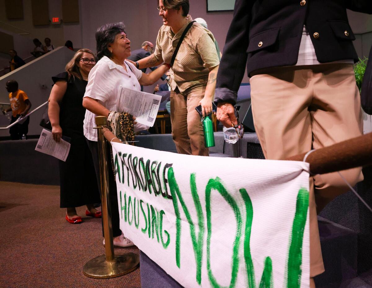 Rachel Prestipino, from Catalyst Miami, center, greets an attendee after the PACT Nehemiah Action Assembly on Monday, April 7, 2025, at Sweet Home Missionary Baptist Church in Cutler Bay, Fla. Affordable housing was the focus at this year’s PACT assembly.