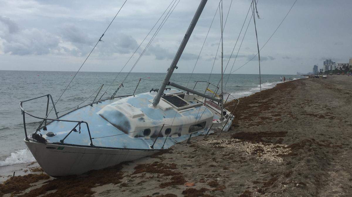 Chad Lisi's 32-foot sailboat has been lodged on Hollywood beach for nearly a month and a half.  On Friday, Hollywood can officially take ownership of the vessel and begin trying to remove the boat, though the owner says towing it back out to sea could cost as much as $20,000.