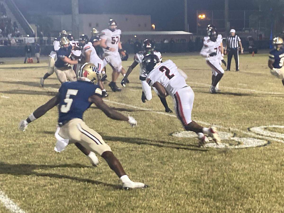 Miami Southridge running back tries to elude West Boca defender Jaydin Broadnax during Friday’s Class 6A state semifinal at West Boca Raton High School.