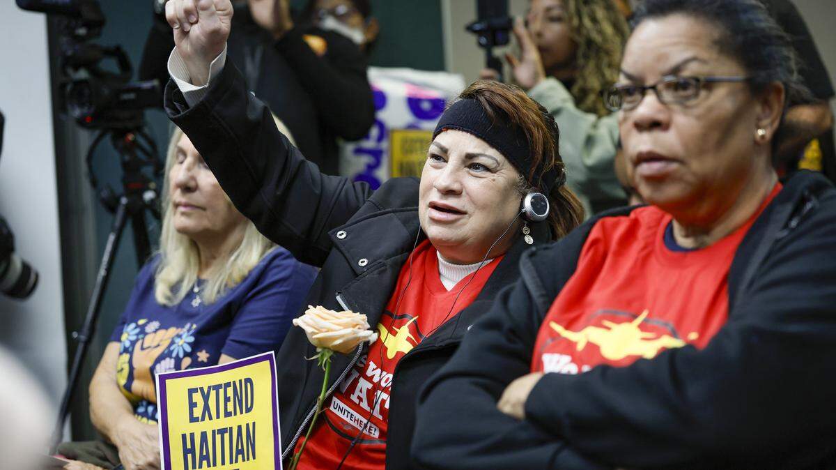Union worker Marta Cabrerra, at center, reacts during a press conference, candlelight vigil, and interfaith prayer at Fort Lauderdale–Hollywood International Airport on Jan. 28, 2026, calling on the Trump Administration to extend Temporary Protected Status for Haitians.