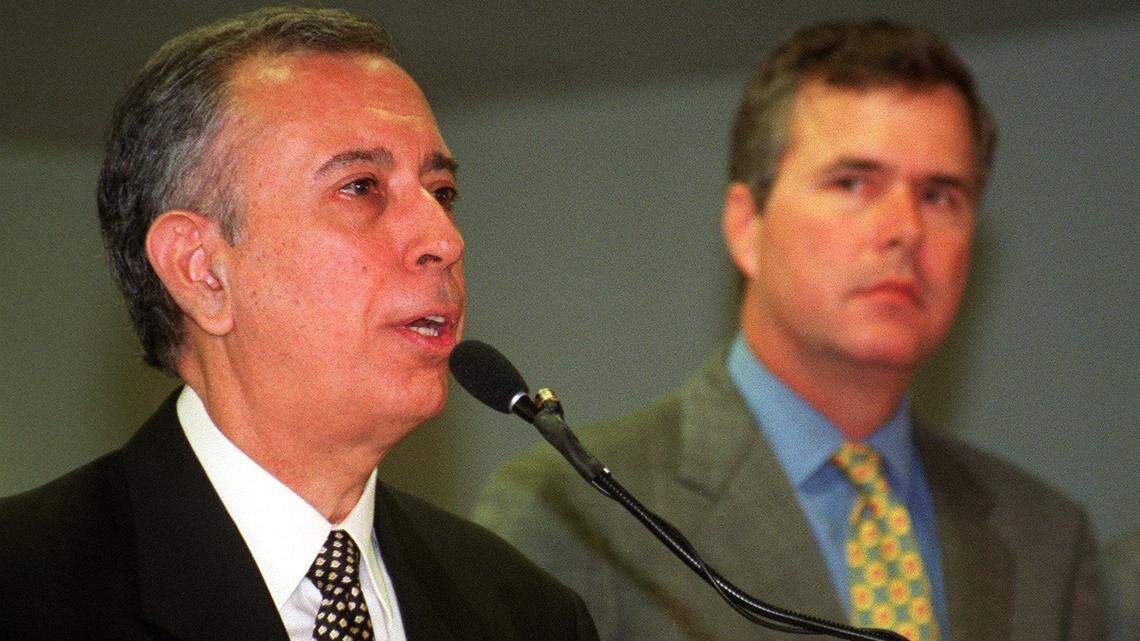 In 2000, then-FIU President Mitch Maidique speaks about the importance of a new law school as Gov. Jeb Bush listens.