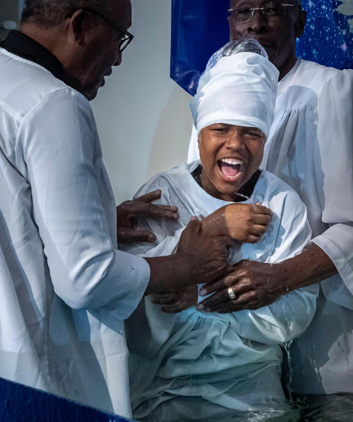 Twelve year-old Max Sanford reacts after being baptized during a Tuesday service at New Shiloh Missionary Baptist Church.