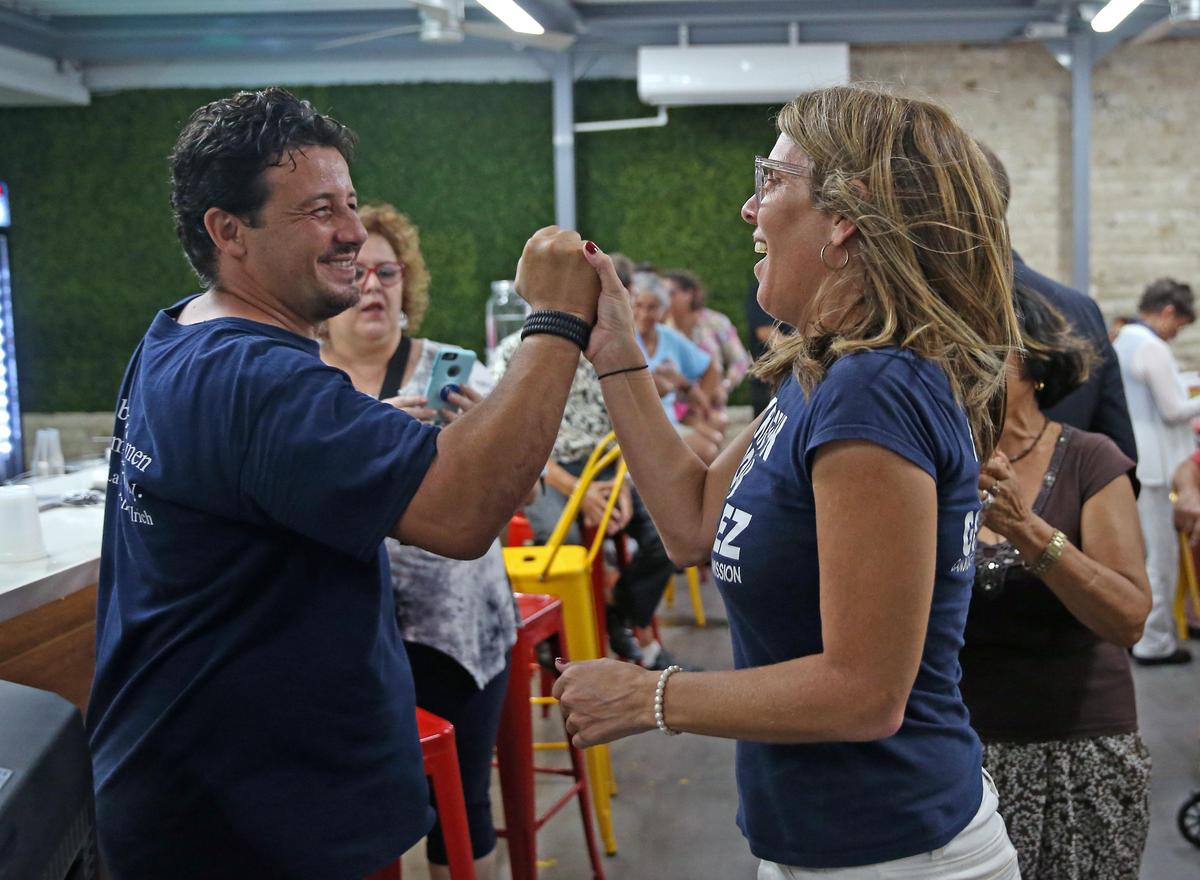 Miami Beach commissioner candidate in Group IV Kristen Rosen Gonzalez high fives supporter Gaston Avila during her election night party Nov. 5, when she won a spot in the runoff. But she was defeated Nov. 19 by Steven Meiner.