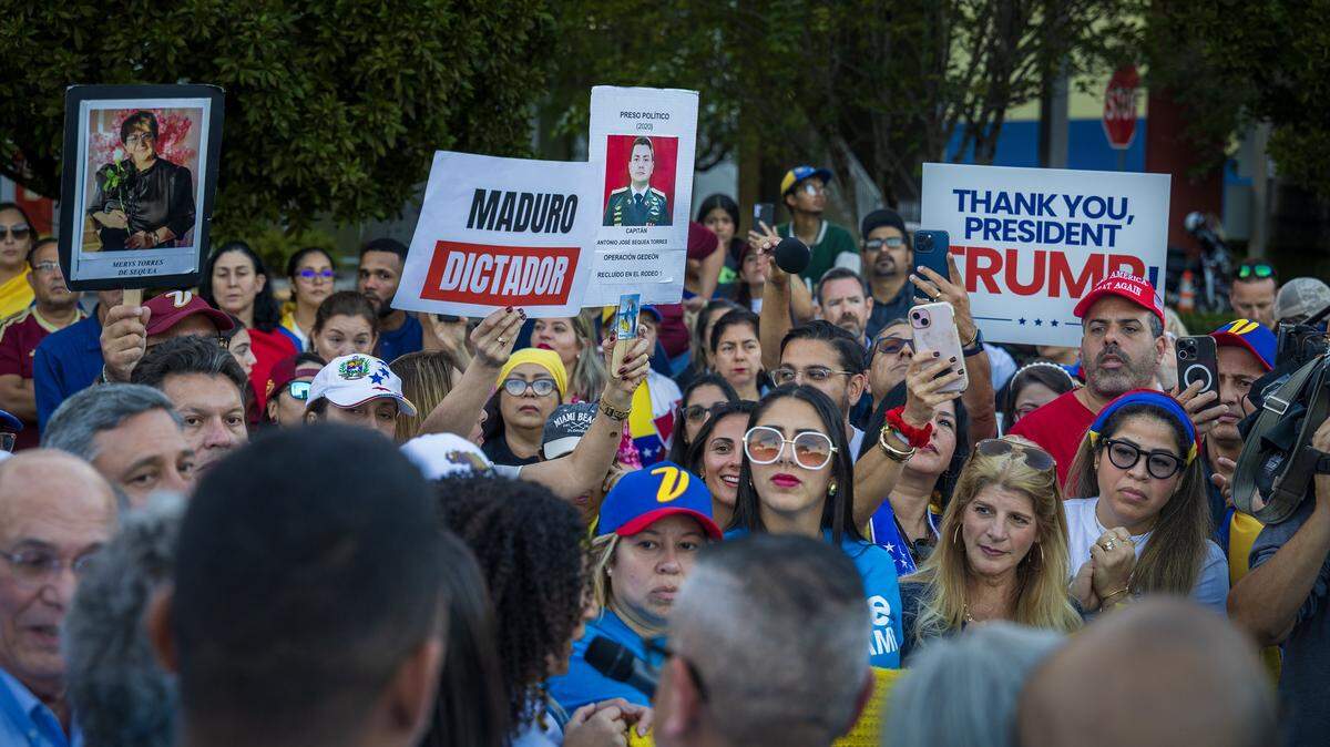 Venezuelans displayed posters with images of political prisoners and others thanking U.S. President Donald J. Trump, during a celebration rally outside of El Arepazo in Doral, Florida, a day after the United States attacked Venezuela and captured leader Nicolás Maduro and his wife Cilia Flores, on January 04, 2026.