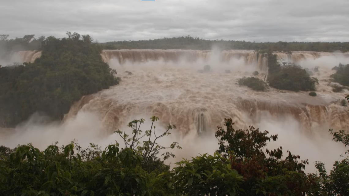 Huge rain storms caused Iguazu falls, a waterfall along the border of Argentina and Brazil, to swell ten times its normal size, videos show.