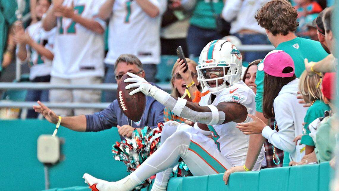 Miami Dolphins free safety Jevon Holland (8) celebrates with fans after intercepting the ball in the first quarter against the Houston Texans at Hard Rock Stadium in Miami Gardens on Sunday, November 7, 2021