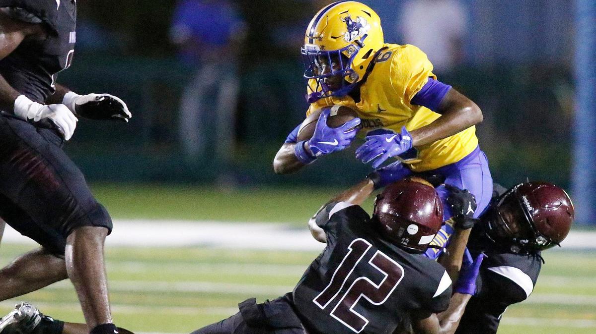 Norland Vikings defenders tackle Northwestern Bulls wide receiver Daruis Johnson (6) during football game on Friday, September 13, 2024 at Traz Powell Stadium in Miami. Andrew Uloza / for Miami Herald