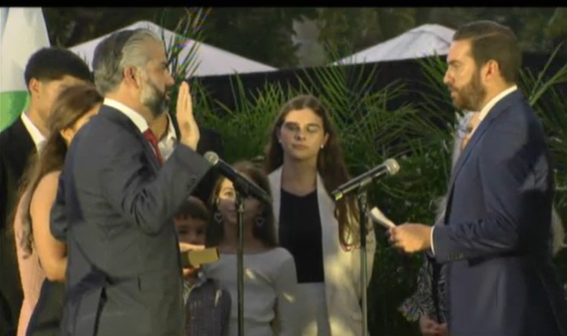 Anthony Rodriguez, left, takes the oath as Miami-Dade County Commission chair on Dec. 11, 2024, at the Phillip and Patricia Frost Science Museum. Florida House Speaker Daniel Perez administers the oath.