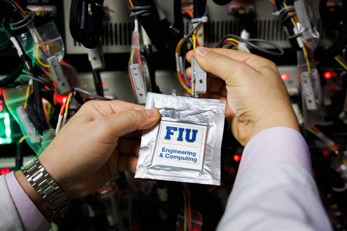 Dr. Bilal El-Zahab holds a Lithium-Sulfur battery during a tour of the Battery Research Laboratory on Thursday, March 20, 2025, at the FIU Engineering Center in Miami, Fla. Dr. El-Zahab’s laboratory has created a Lithium-sulfur battery that could replace Lithium-ion rechargeable batteries.