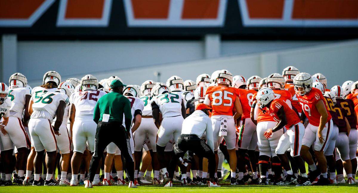 Miami Hurricanes football players huddle on the field during football practice at the University of Miami campus in Coral Gables, Florida, Tuesday, August 30, 2022.