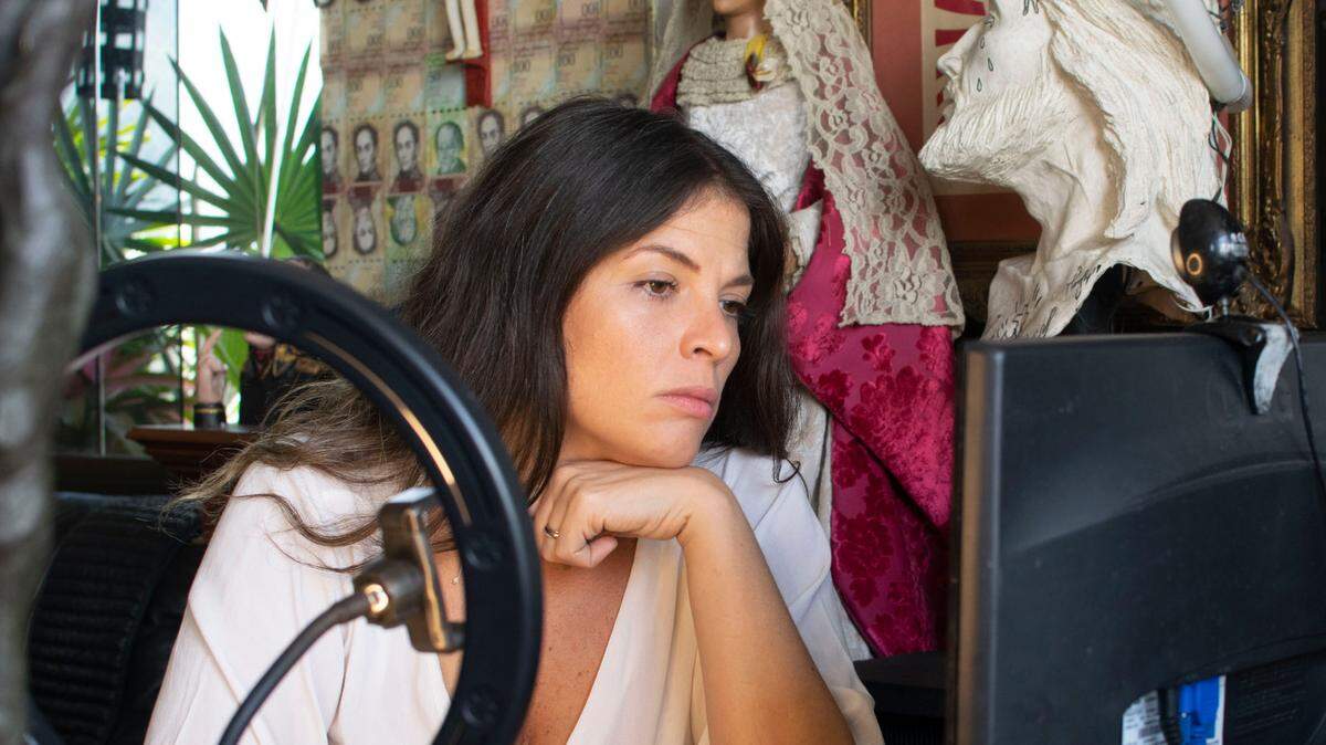 Stephanie Cardone Fulop looks at her computer in Caracas, Venezuela, on May 15, 2021. Venezuelan women have begun taking to social media to share stories of abuse.