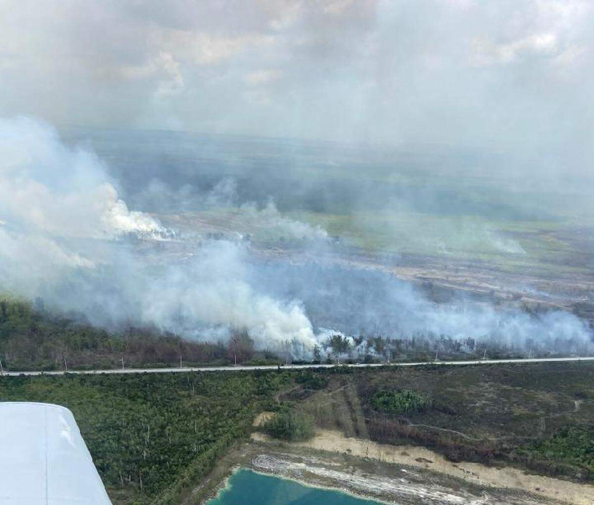An aerial view shows smoke from a large brush fire in south Miami-Dade County that has shut down Card Sound Road leading into the Florida Keys Monday, May 3, 2021.