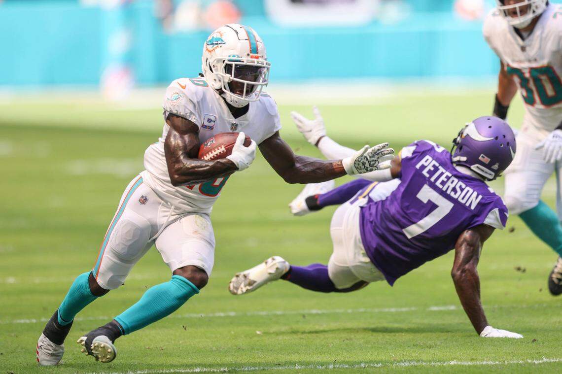 Miami Dolphins wide receiver Tyreek Hill (10) runs past Minnesota Vikings cornerback Patrick Peterson (7) during a NFL football game, Sunday, Oct.16, 2022 in Miami Gardens, Fla. (AP Photo/Alex Menendez)