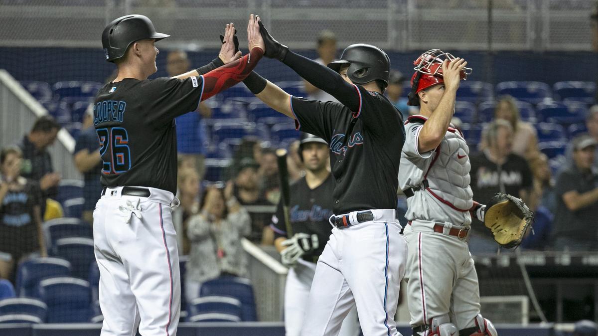 Miami Marlins right fielder Brian Anderson (15) celebrates with Garrett Cooper after hitting a home run in the third inning against the Philadelphia Phillies on Friday, June 28, 2019, at Marlins Park.