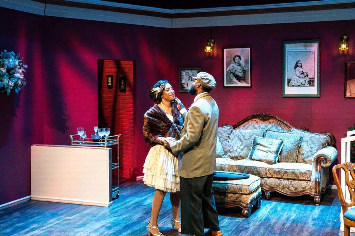Yolande Du Bois (Dina Lewis) and Jimmy Lunceford (Jean Hyppolite) after a night on the town in the Du Bois’s Harlem apartment living room.