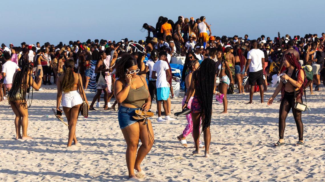 Spring breakers socialize on the beach during Spring Break in Miami Beach, Florida, on Saturday, March 18, 2023.
